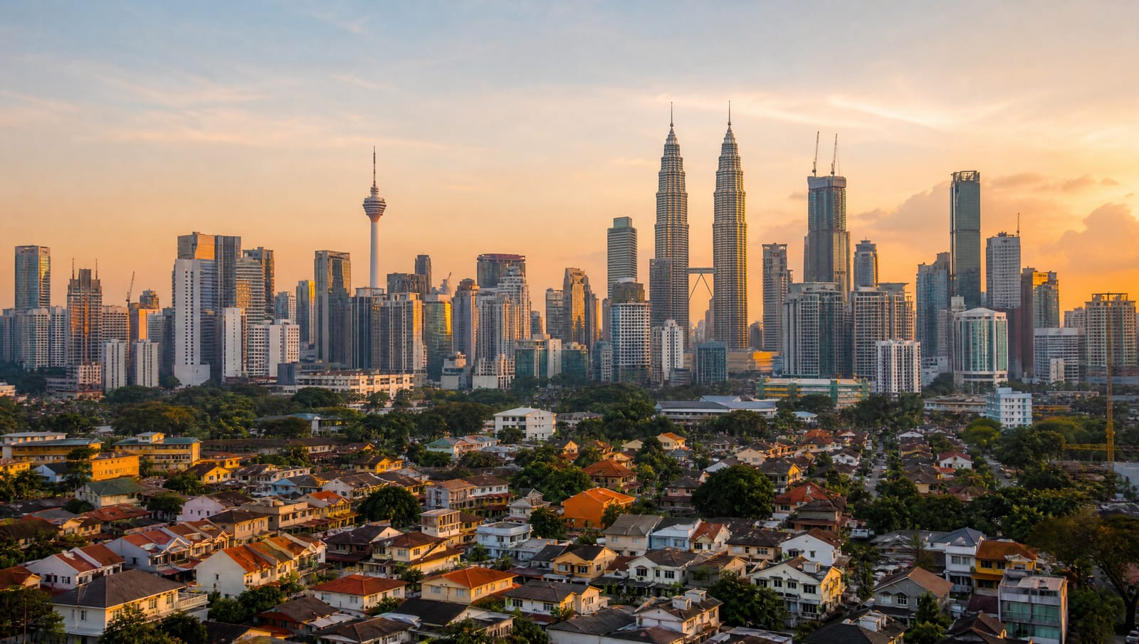 Kuala Lumpur and Klang Valley skyline at golden hour, including the Petronas Twin Towers