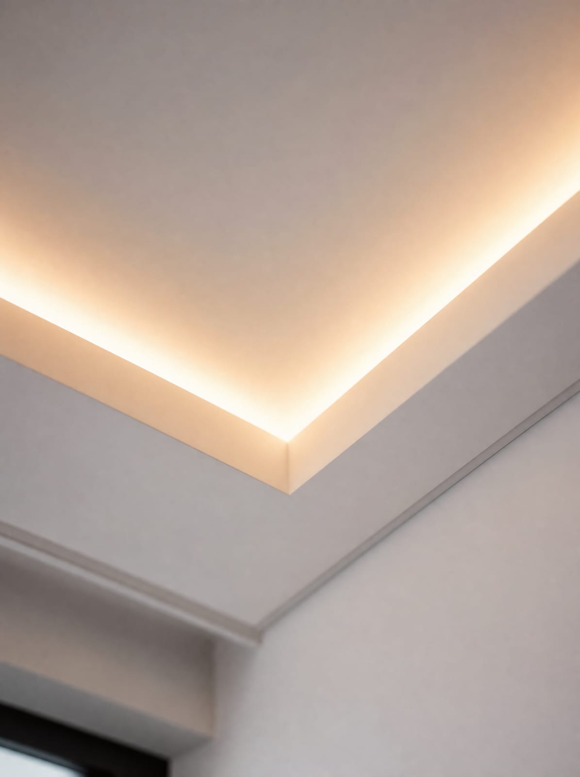 Ceiling cove recess with concealed cable trunking and a warm LED light strip along the edge