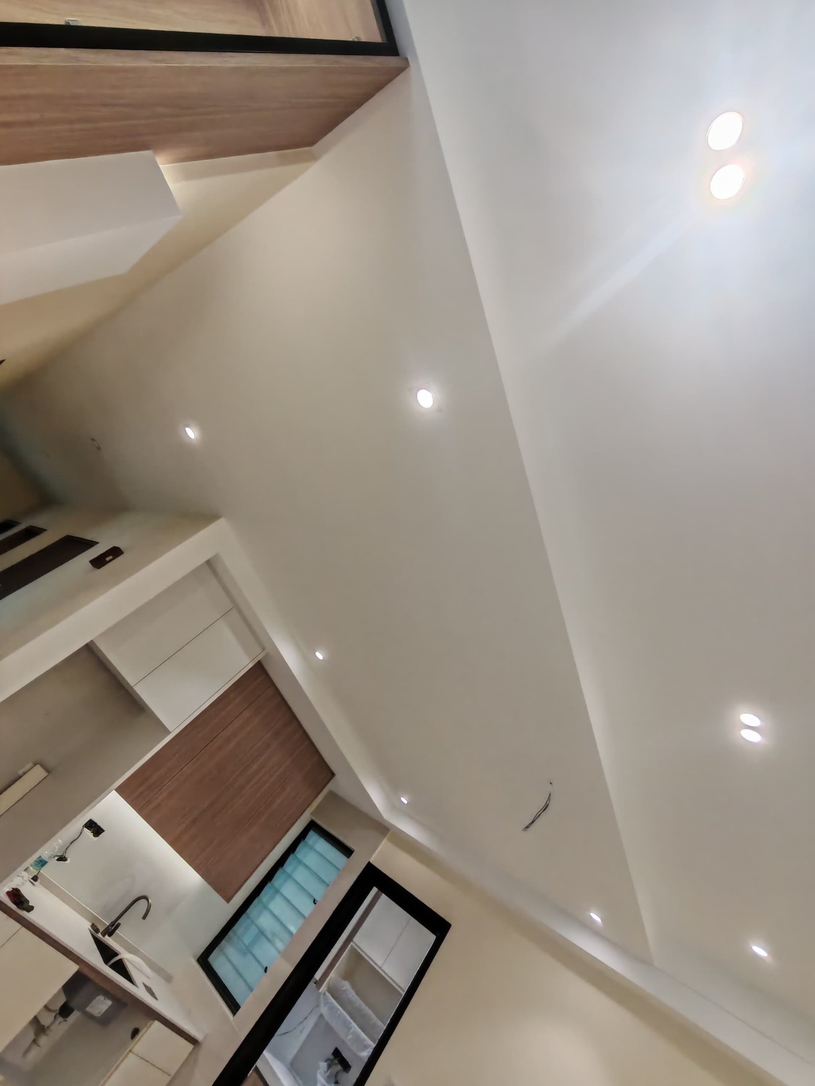 Downlight Ceiling Near Kitchen and Wet Area Plaster ceiling with recessed downlights near kitchen and wet area, wood-tone cabinetry and aircon cassette unit, Sungai Long house renovation