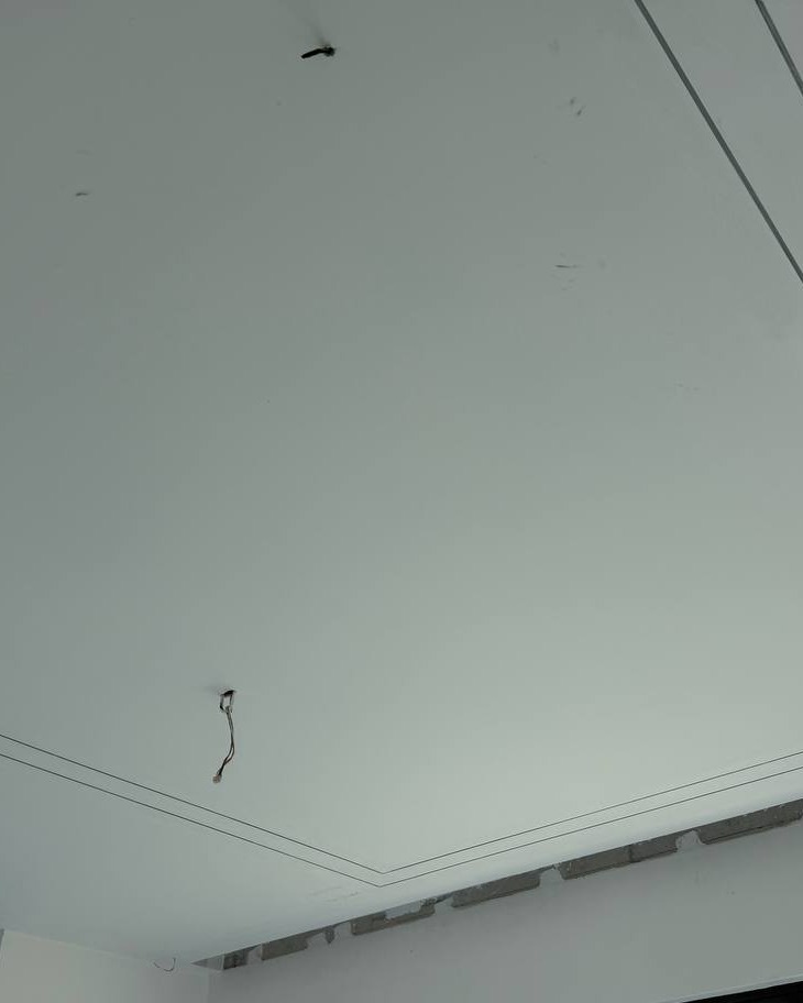 Plaster Ceiling with Cove Light Groove – Cyberjaya Staircase Flat plaster ceiling in Cyberjaya staircase area with recessed cove lighting groove outline and exposed wiring point awaiting fixture installation