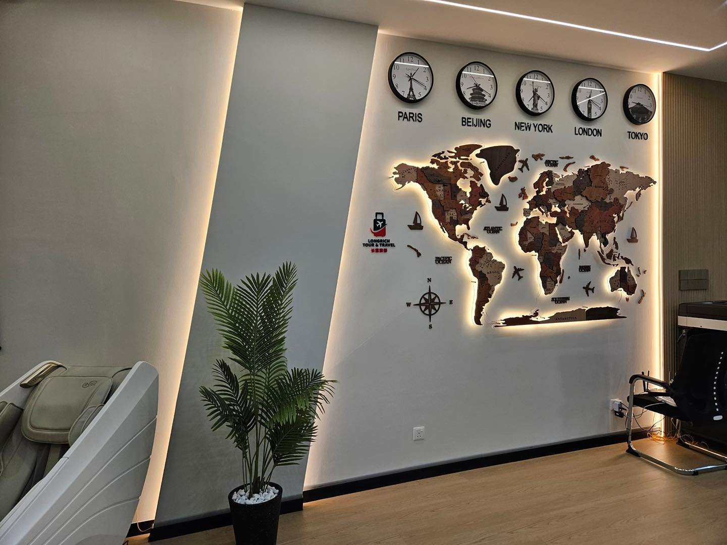 Reception Feature Wall with Cove Lighting - Kepong Office Recessed ceiling cove lighting above a backlit decorative world map feature wall with world city clocks, Longrich Tour & Travel reception area, Kepong office fit-out