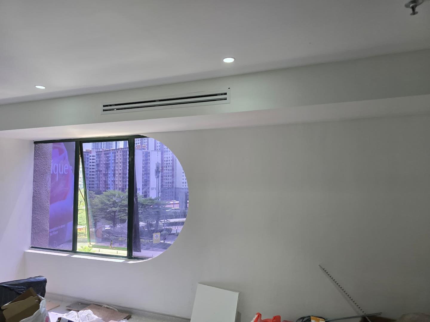 Curved Partition with Oval Viewport – Mid Valley Salon Curved partition wall with oval viewport window cut-out and recessed aircon diffuser above, Mid Valley beauty salon renovation
