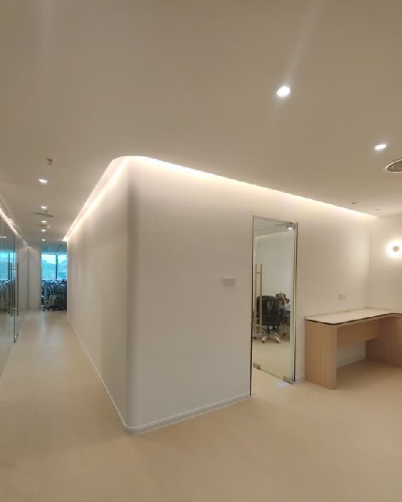 Curved plaster partition wall with recessed cove lighting and flush ceiling in Southbank Residence strata office renovation, Old Klang Road, Kuala Lumpur