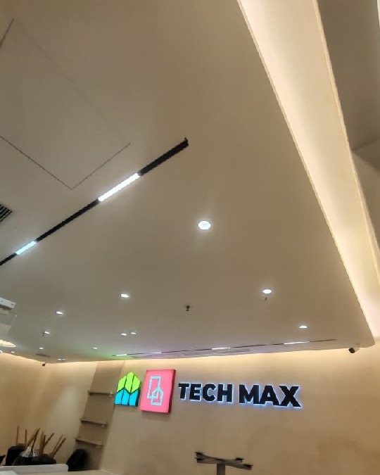 Multi-level plaster ceiling with recessed spotlights and linear cove lighting above Tech Max signage in Southbank Residence strata office renovation, Old Klang Road, Kuala Lumpur