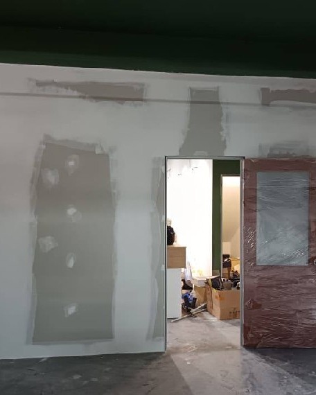 Plastered Partition Wall with Doorway - Shah Alam Office Freshly plastered partition wall with filled joint lines and doorway opening, plaster ceiling and partition wall installation project in Shah Alam office