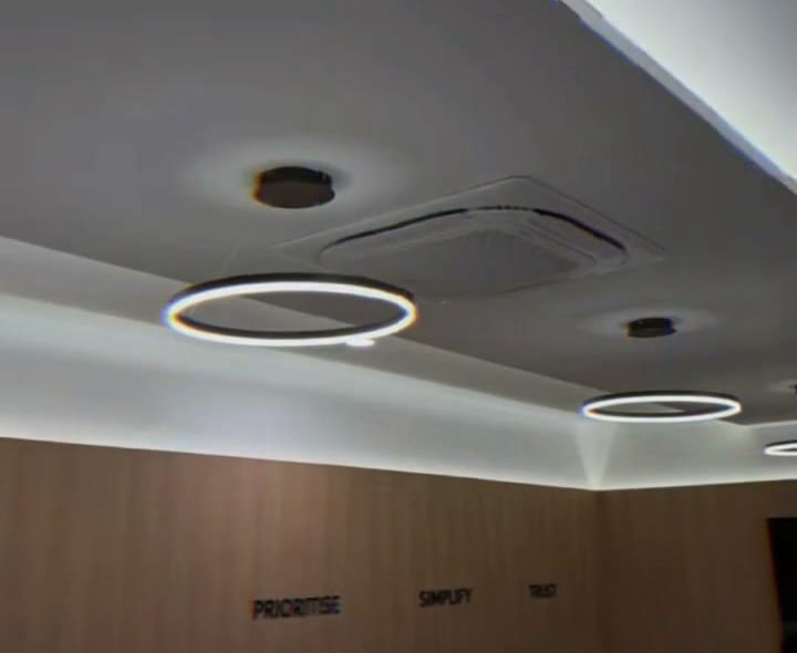 Boardroom plaster ceiling with perimeter cove lighting, ring pendants and a ceiling-cassette aircon, Shah Alam office