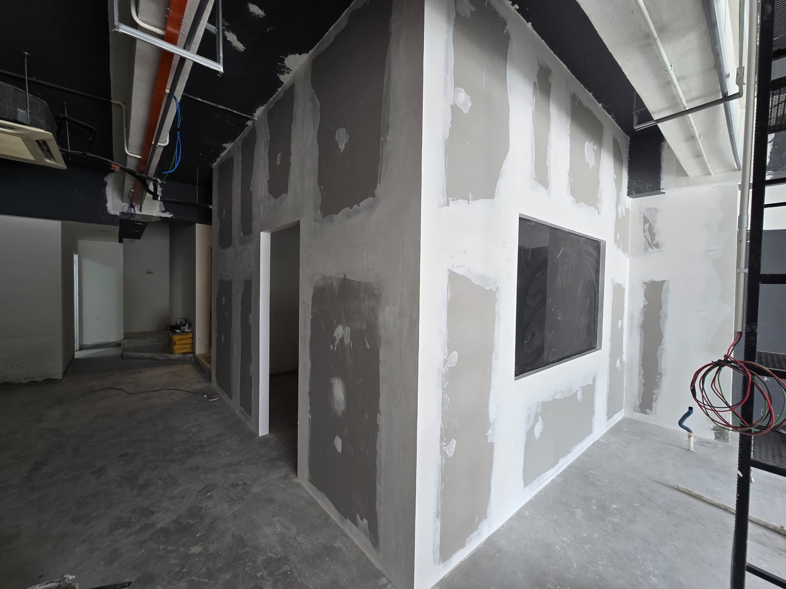 Grooming room partition under construction Barberroom by Jiro fit-out — gypsum partition wall enclosing a private grooming room under construction